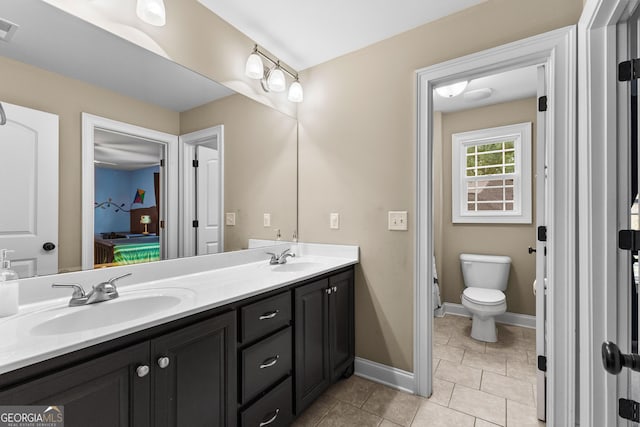 bathroom featuring tile patterned floors, vanity, and toilet