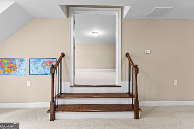 stairs with carpet floors and vaulted ceiling