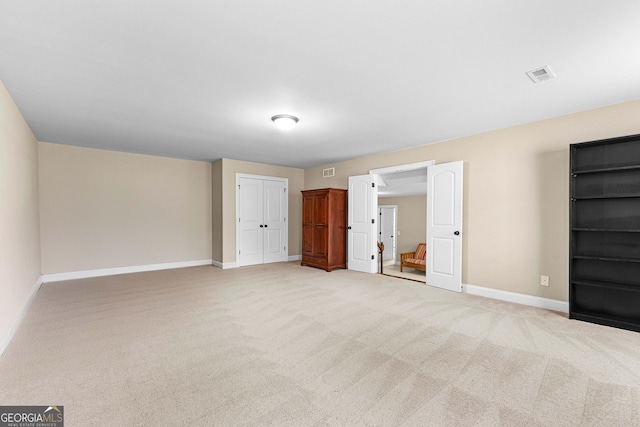 unfurnished bedroom with light colored carpet