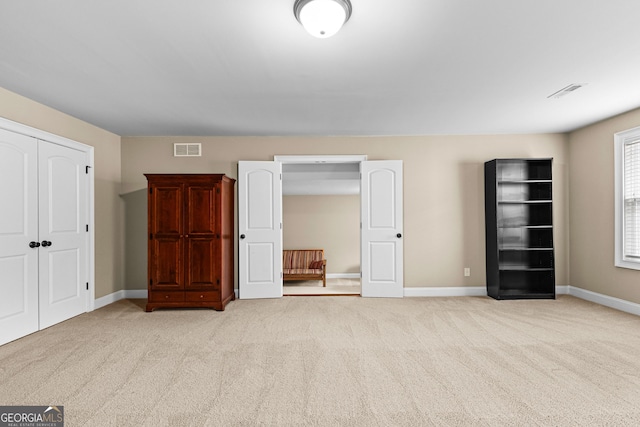 unfurnished bedroom featuring light colored carpet