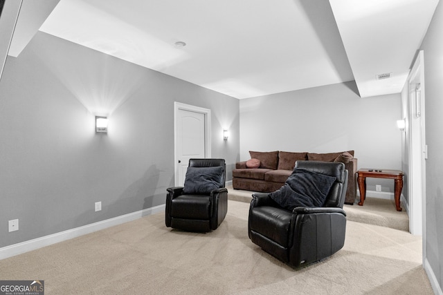 cinema room featuring light carpet