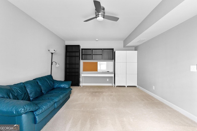 carpeted living room with ceiling fan