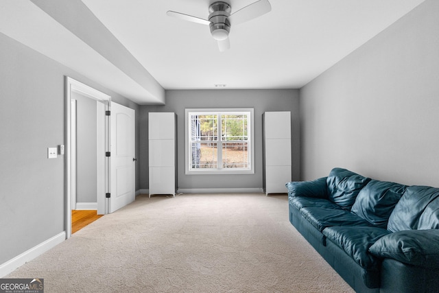 living room with light carpet and ceiling fan