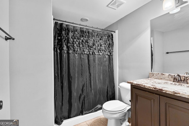 bathroom with tile patterned floors, vanity, curtained shower, and toilet