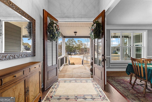 doorway to outside featuring wood-type flooring, crown molding, and french doors