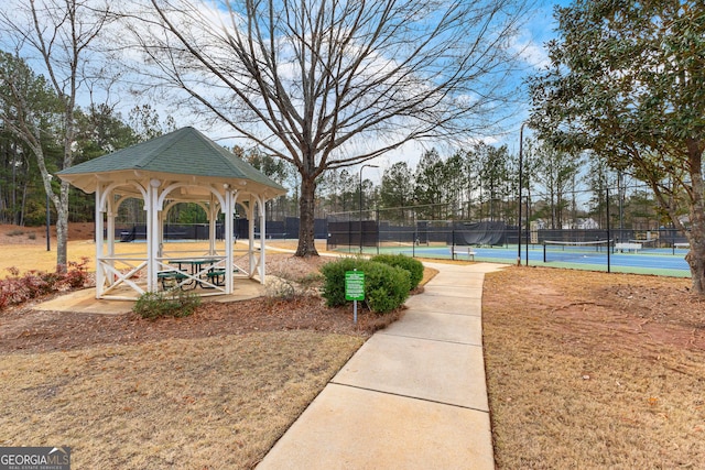 view of home's community with a gazebo and tennis court