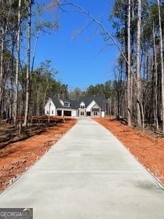 view of street featuring concrete driveway