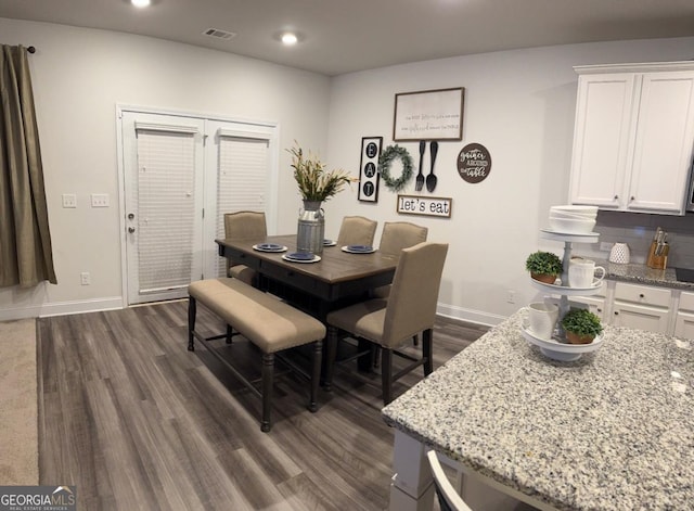 dining area with dark wood-type flooring