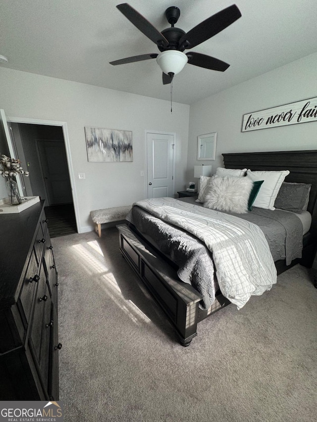 carpeted bedroom featuring a closet and ceiling fan