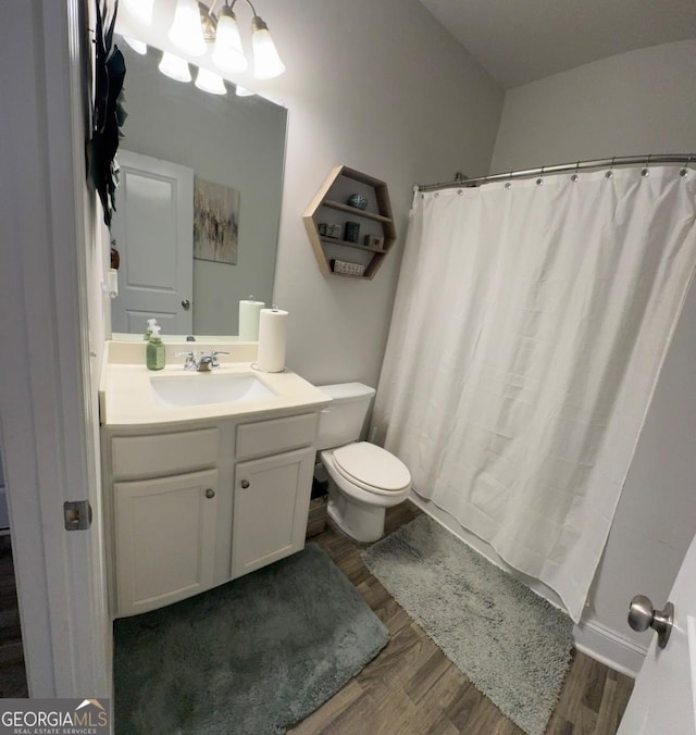 bathroom with hardwood / wood-style flooring, vanity, toilet, and a shower with shower curtain