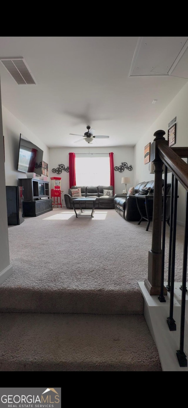 carpeted living room featuring ceiling fan