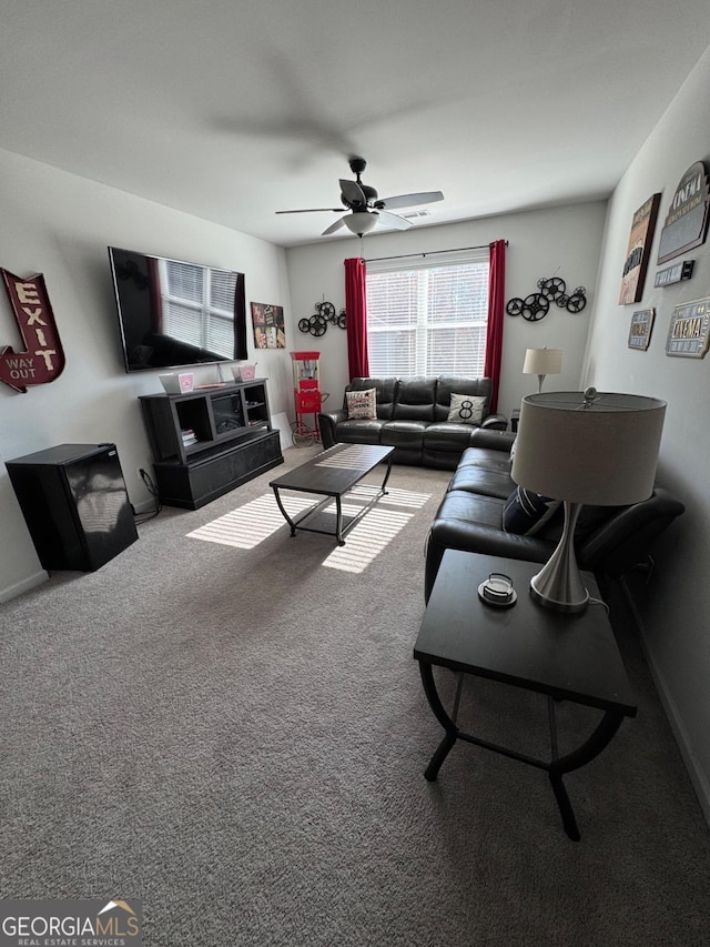 carpeted living room with ceiling fan