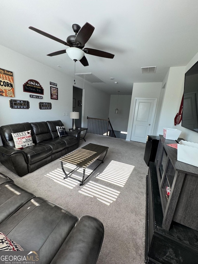 living room featuring carpet flooring and ceiling fan