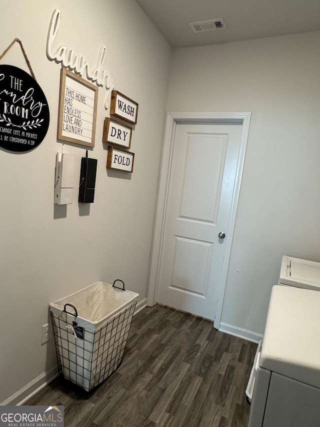 laundry room featuring washing machine and dryer and dark wood-type flooring