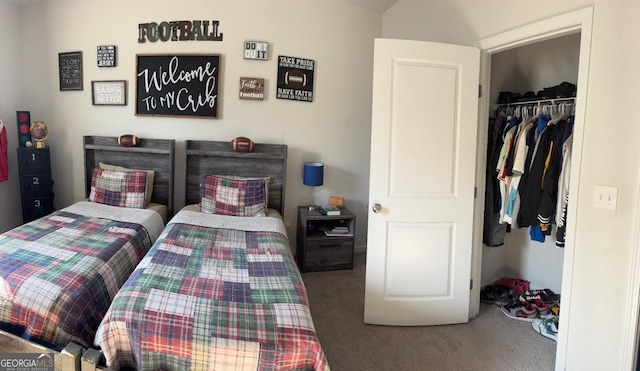 carpeted bedroom featuring a walk in closet and a closet