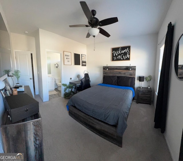 bedroom with connected bathroom, light carpet, and ceiling fan