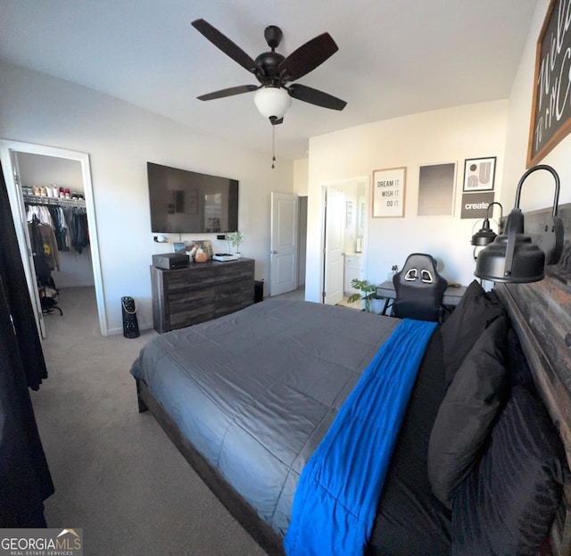 carpeted bedroom featuring a spacious closet, a closet, and ceiling fan