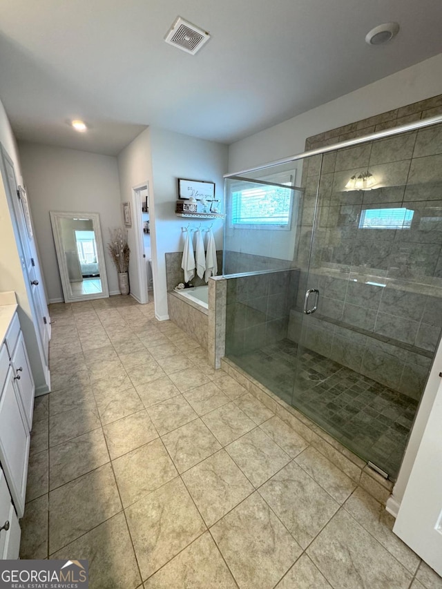 bathroom with separate shower and tub, tile patterned flooring, and vanity