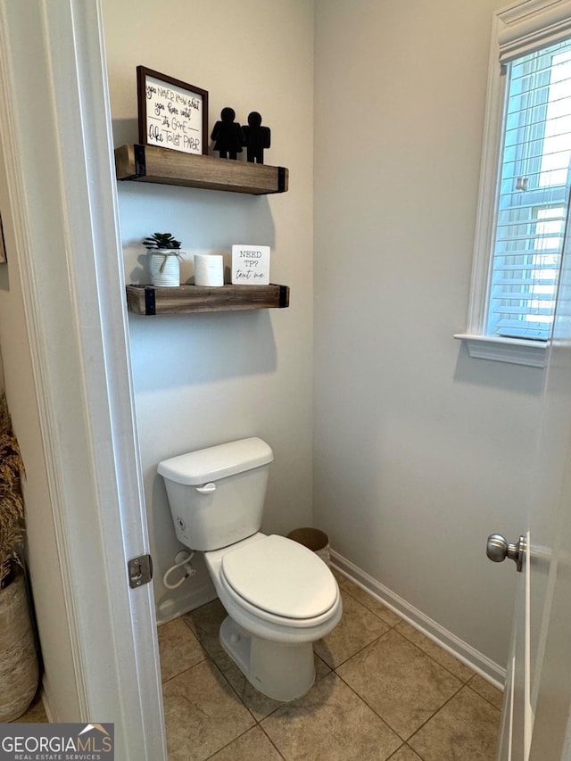 bathroom with tile patterned flooring and toilet