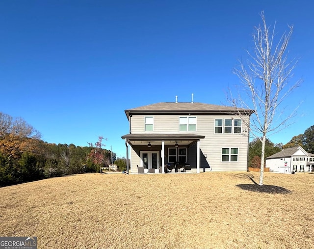 rear view of property with a patio area, ceiling fan, and a yard