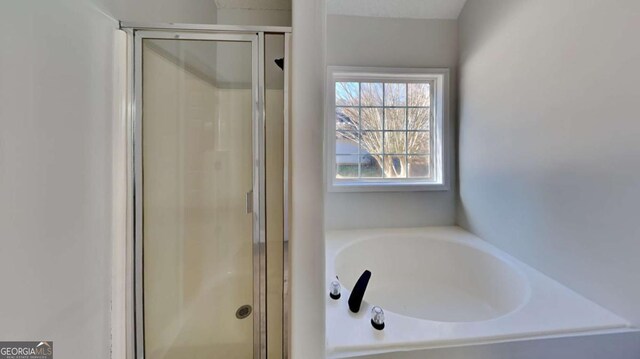 bathroom with separate shower and tub