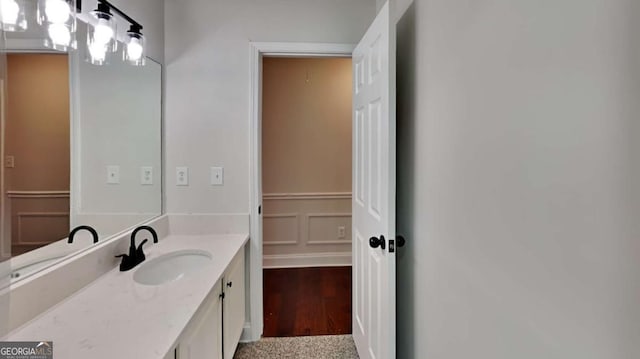 bathroom with hardwood / wood-style floors and vanity