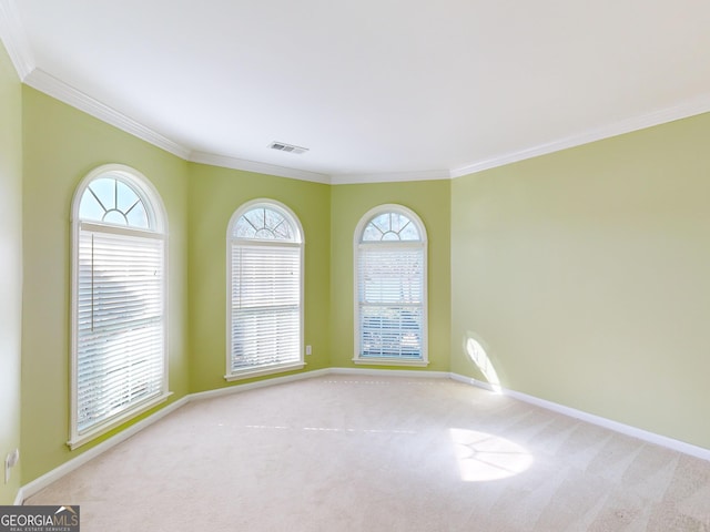 carpeted spare room with crown molding