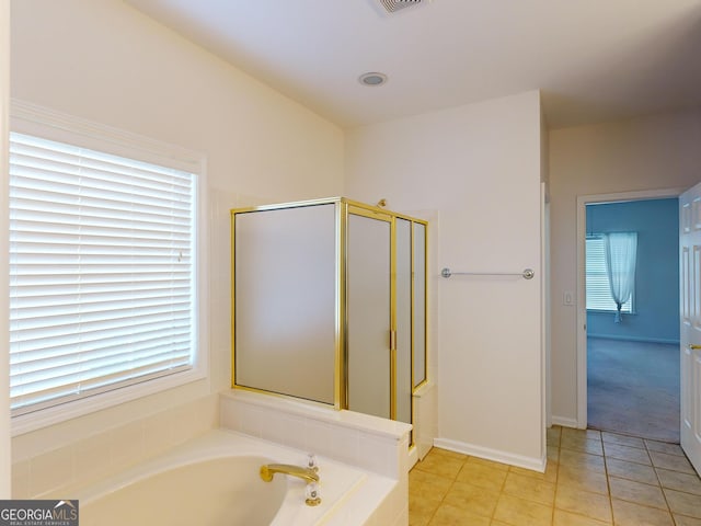 bathroom with tile patterned floors, a wealth of natural light, and separate shower and tub