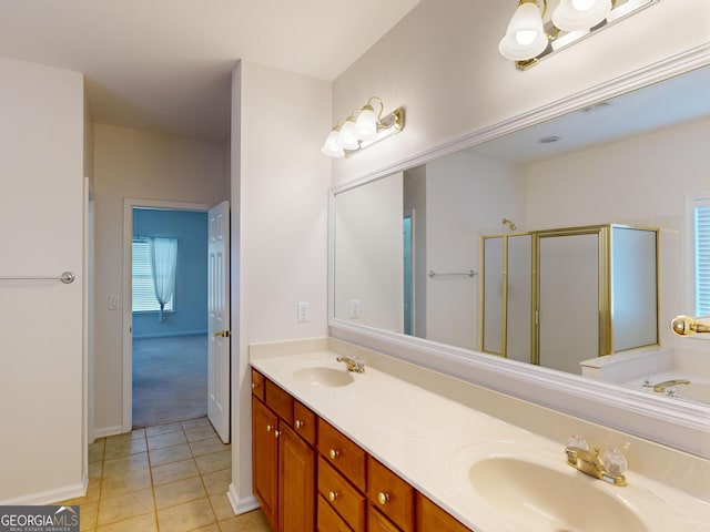 bathroom with tile patterned flooring, vanity, and an enclosed shower