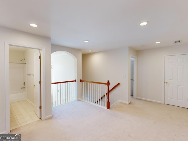 hallway with light colored carpet