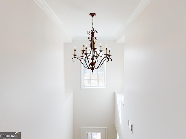 room details with an inviting chandelier and crown molding