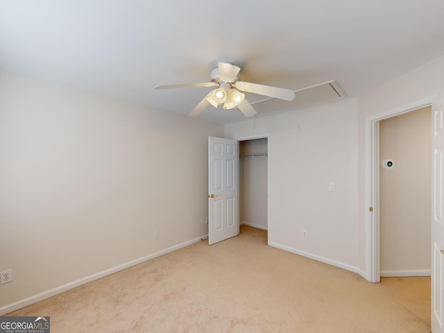 unfurnished bedroom with ceiling fan, light carpet, and a closet