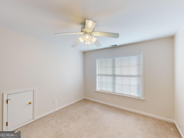 carpeted empty room featuring ceiling fan