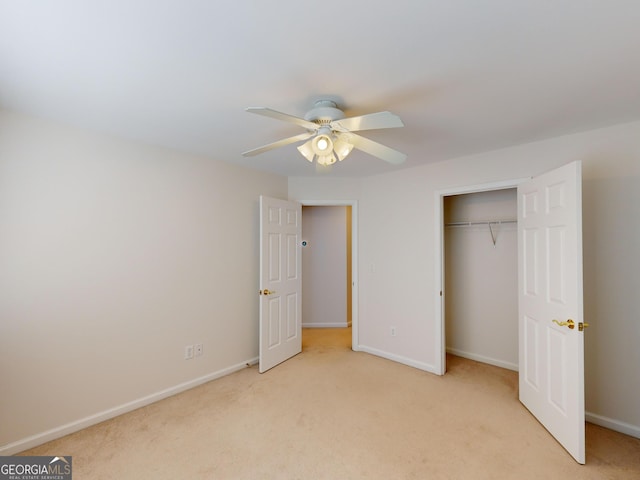 unfurnished bedroom with ceiling fan, light carpet, and a closet