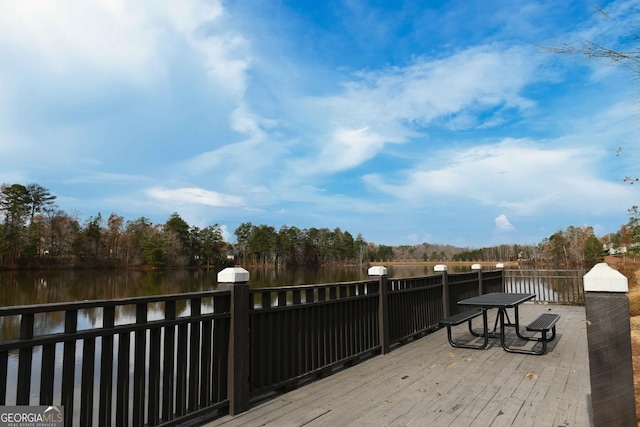 wooden terrace featuring a water view