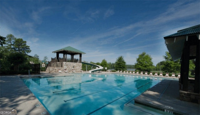 view of pool with a water slide