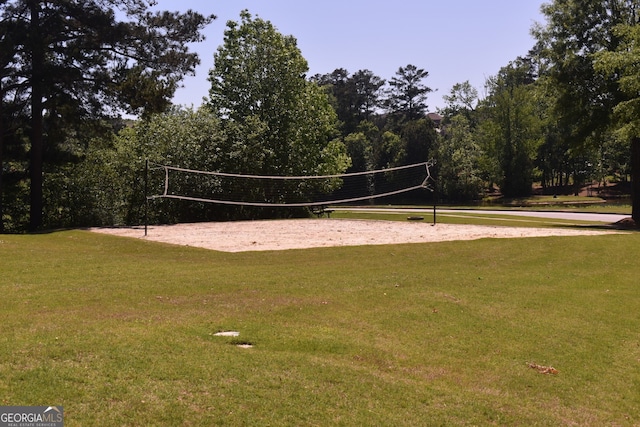 surrounding community with volleyball court and a yard