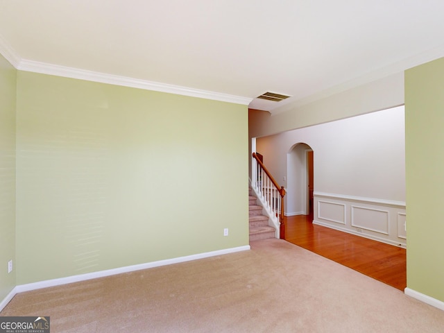 carpeted empty room with ornamental molding