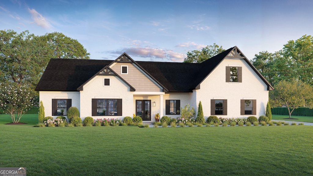 view of front facade with a front yard and french doors