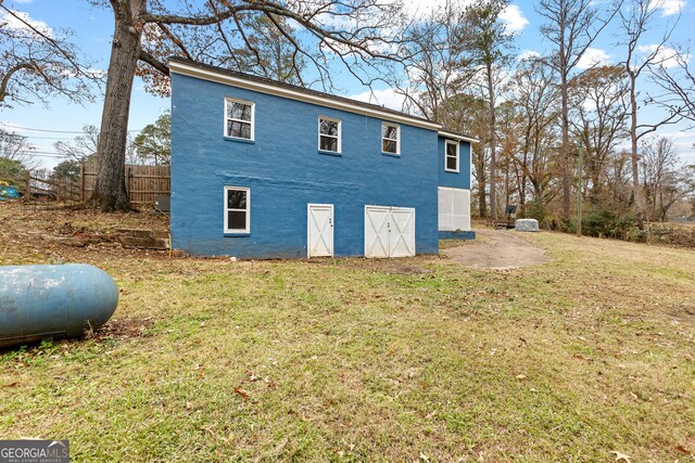 view of side of home with a lawn