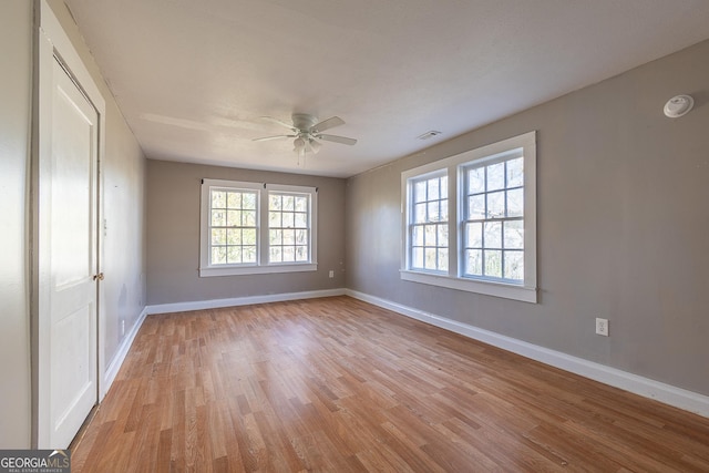 spare room with light hardwood / wood-style floors and ceiling fan