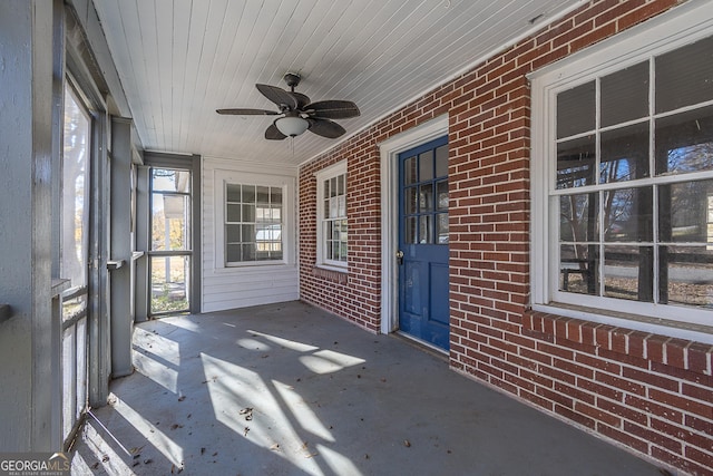 unfurnished sunroom featuring ceiling fan and wood ceiling