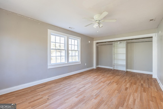 unfurnished bedroom with light wood-type flooring, a closet, and ceiling fan