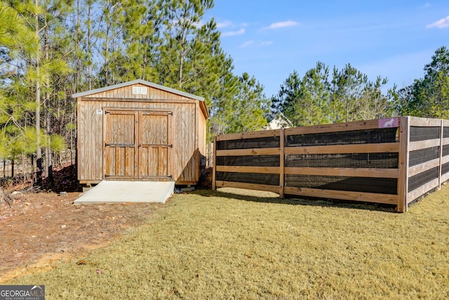 view of outbuilding with a yard