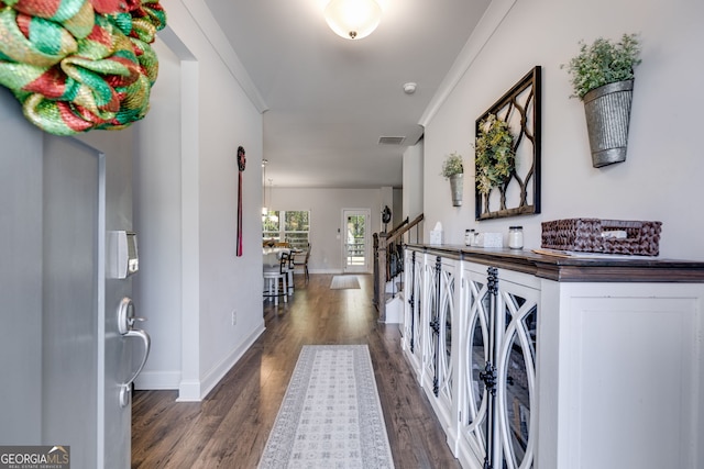 entrance foyer with dark hardwood / wood-style floors and ornamental molding