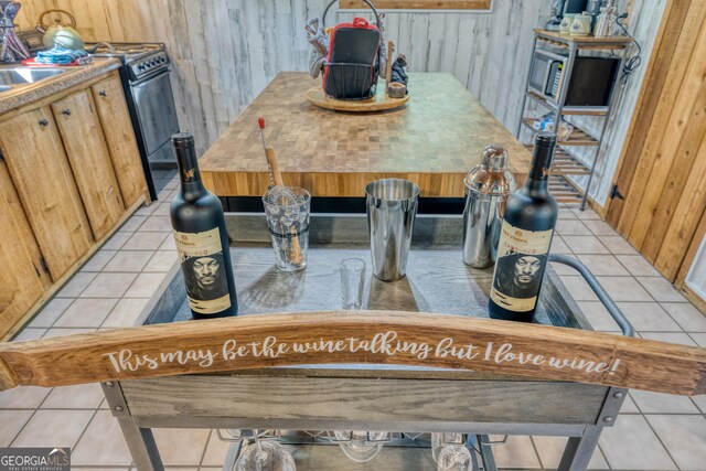 room details with black electric range oven and wooden walls