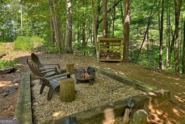 view of yard featuring an outdoor fire pit