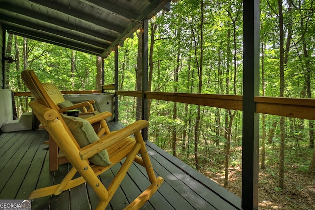 sunroom featuring vaulted ceiling and wooden ceiling