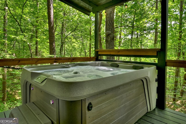 wooden deck featuring a hot tub