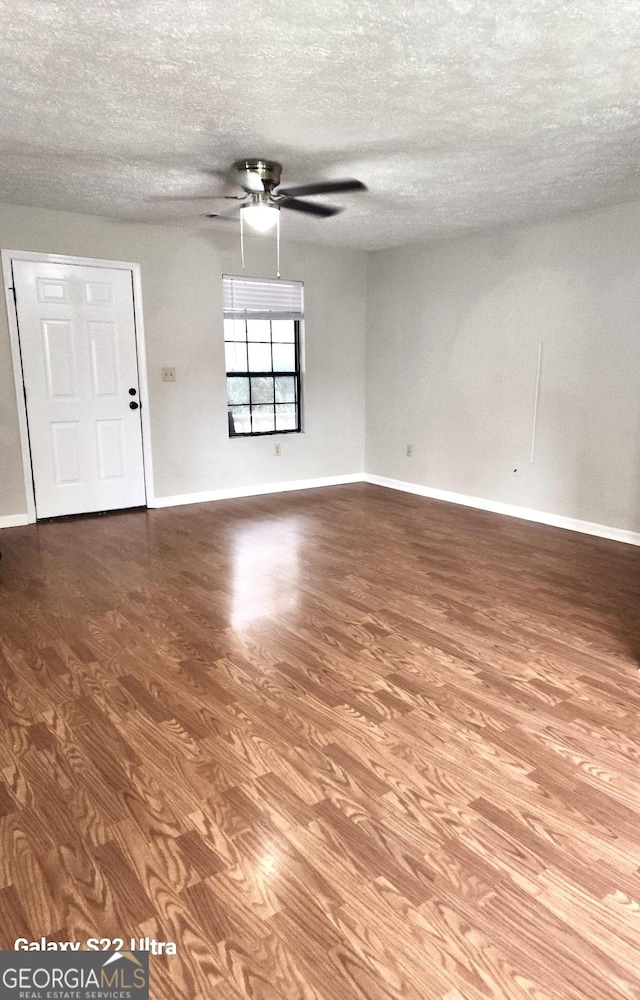 unfurnished room featuring wood-type flooring, a textured ceiling, and ceiling fan